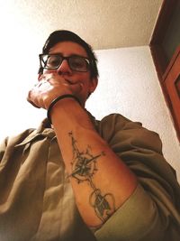 Portrait of woman wearing eyeglasses at home