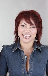 Portrait of smiling woman against gray background