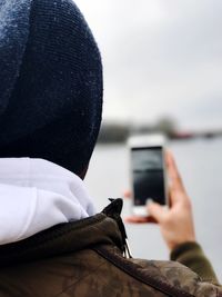 Close-up of hand holding mobile phone