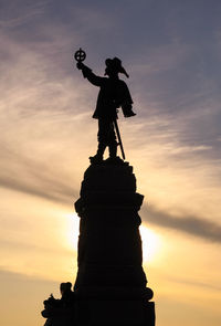 Low angle view of statue at sunset