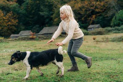 Portrait of woman with dogs on grassy field