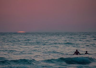 Scenic view of sea against clear sky during sunset