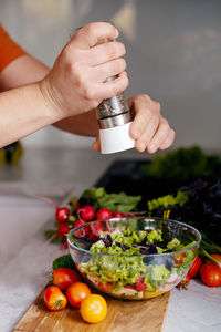 Cropped hand of man preparing food