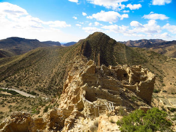 Scenic view of mountains against cloudy sky