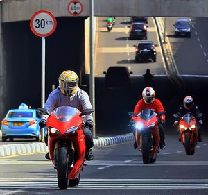 People riding motorcycles on road