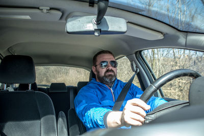 Midsection of man driving car