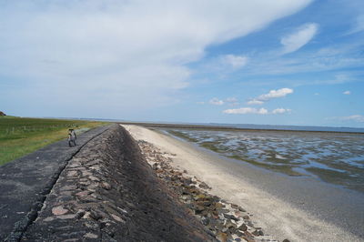 Road by sea against sky