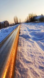 Snow covered landscape against sky