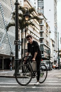 Man riding bicycle on city street