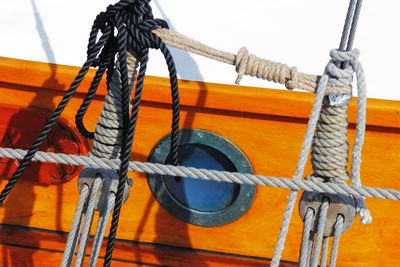 Close-up of ropes against window of ship