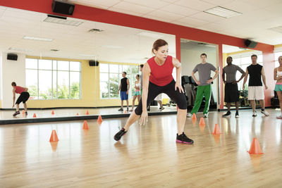 Full length of woman exercising in gym