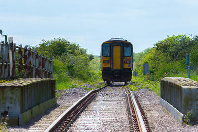 Train on railroad track against sky