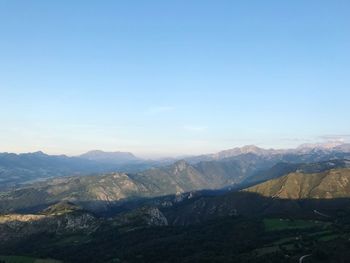 Scenic view of mountains against clear blue sky