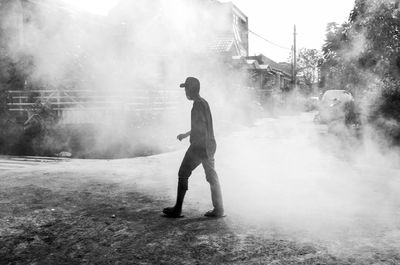 Full length rear view of man walking in city