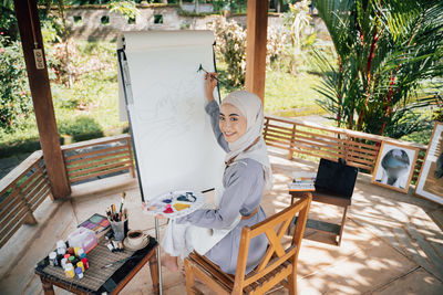 Portrait of woman sitting on chair