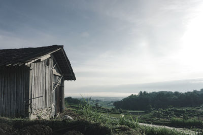 Scenic view of field against sky and a little shack