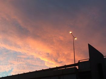 Low angle view of silhouette building against sky during sunset