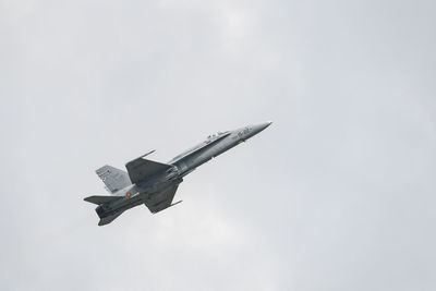 Low angle view of airplane flying against sky