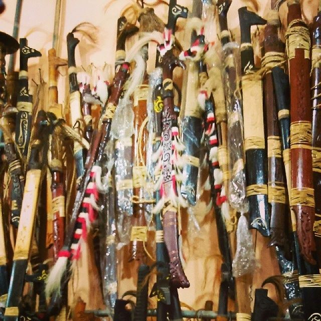 large group of objects, indoors, abundance, variation, retail, for sale, choice, hanging, store, in a row, market, men, market stall, shopping, collection, arrangement, large group of people, sale, display