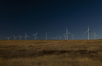 Modern windmills on field against blue sky. shot in castilla la mancha, spain