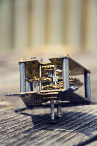 Close-up of old machine part on table