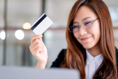 Portrait of young woman using mobile phone