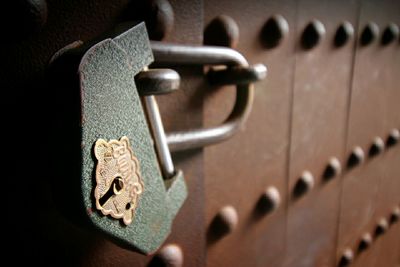 Close-up of padlock hanging from door