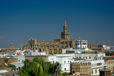 View of cityscape against blue sky