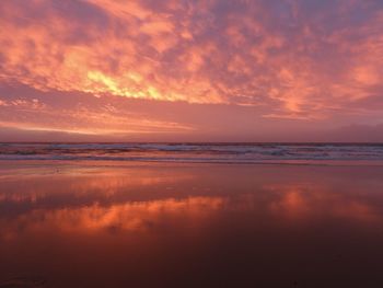 Scenic view of sea against orange sky