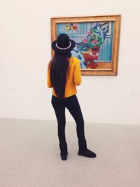 Full length of young woman standing by railing