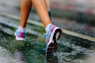 Low section of woman standing in water