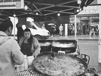 People at market stall in city