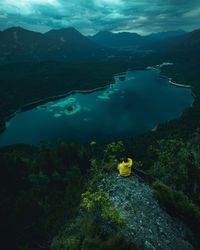 High angle view of lake amidst mountains during dusk