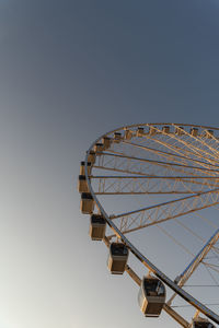 Low angle view of ferris wheel against clear sky