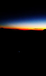 Scenic view of silhouette dark against sky at night