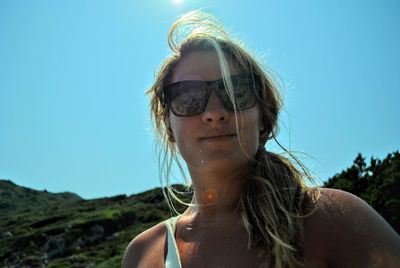 Woman wearing sunglasses against clear sky