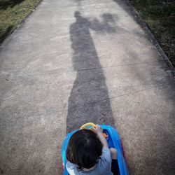 Rear view of boy playing on playground