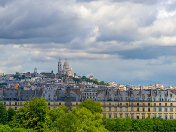 Cityscape of paris, france, with sacre couer in montmartre with cloudy sky