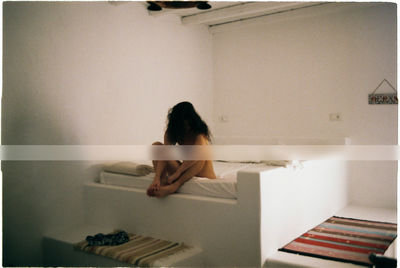 Young woman sitting at home