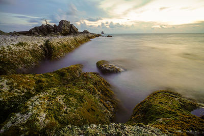 Scenic view of sea against sky at sunset