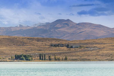 Scenic view of lake and mountains against sky