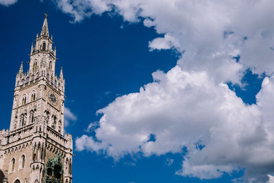 Low angle view of bell tower against cloudy sky