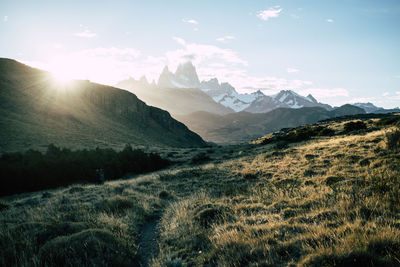 Scenic view of snowcapped mountain peak against sunset sky