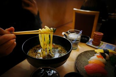 Midsection of man having food on table