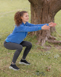 A european woman does sports in a park or a public place. warm-up and jogging in the fresh air