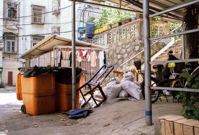 Man sitting on chair against building in city