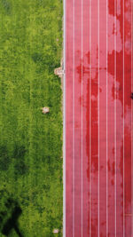 High angle view of field by building