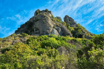 Low angle view of rock formation against sky