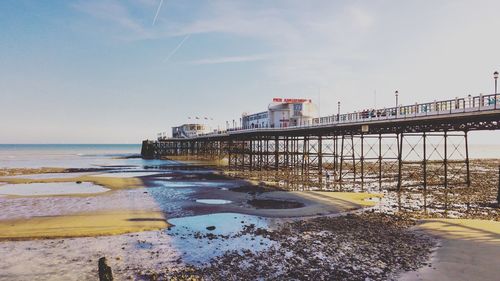 Worthing pier over sea against sky from beach