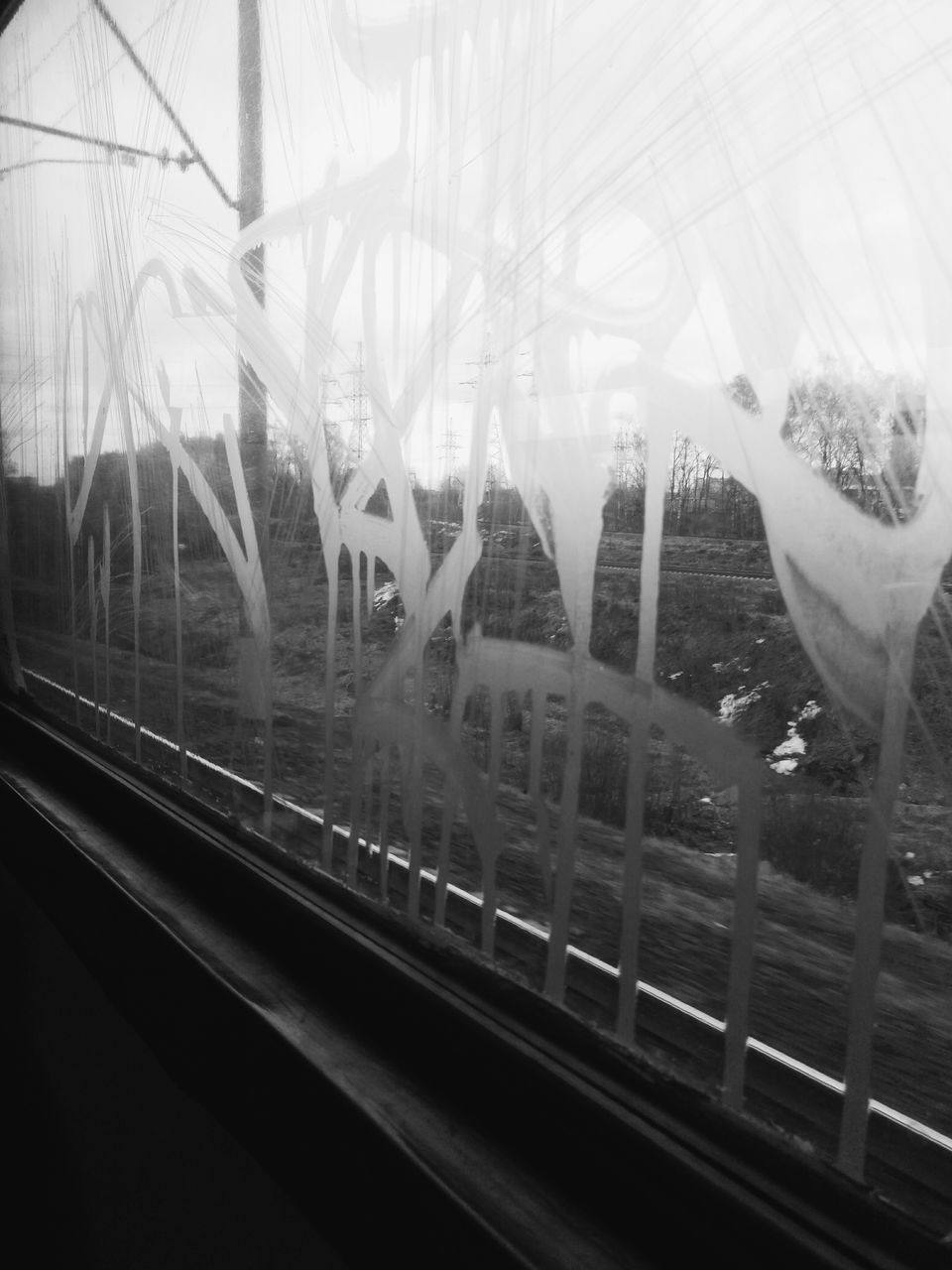 VIEW OF RAILROAD TRACKS THROUGH WINDOW